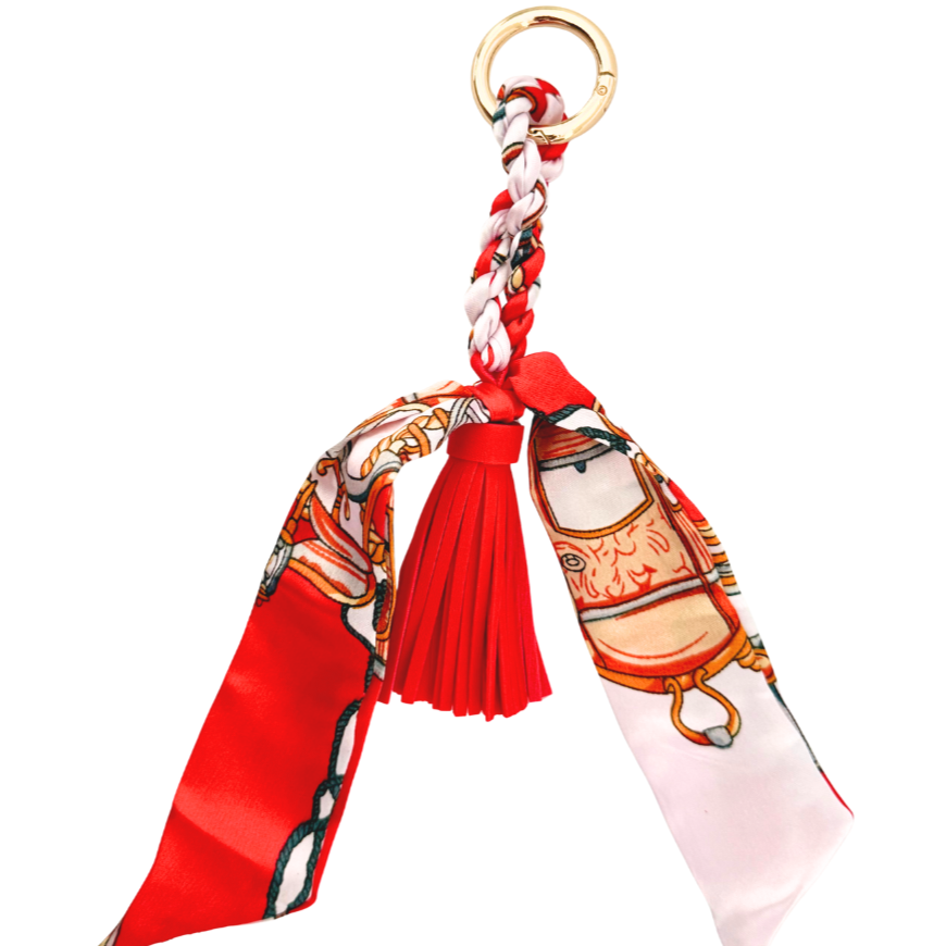 Decorative handbag charm with red ribbon and tassel